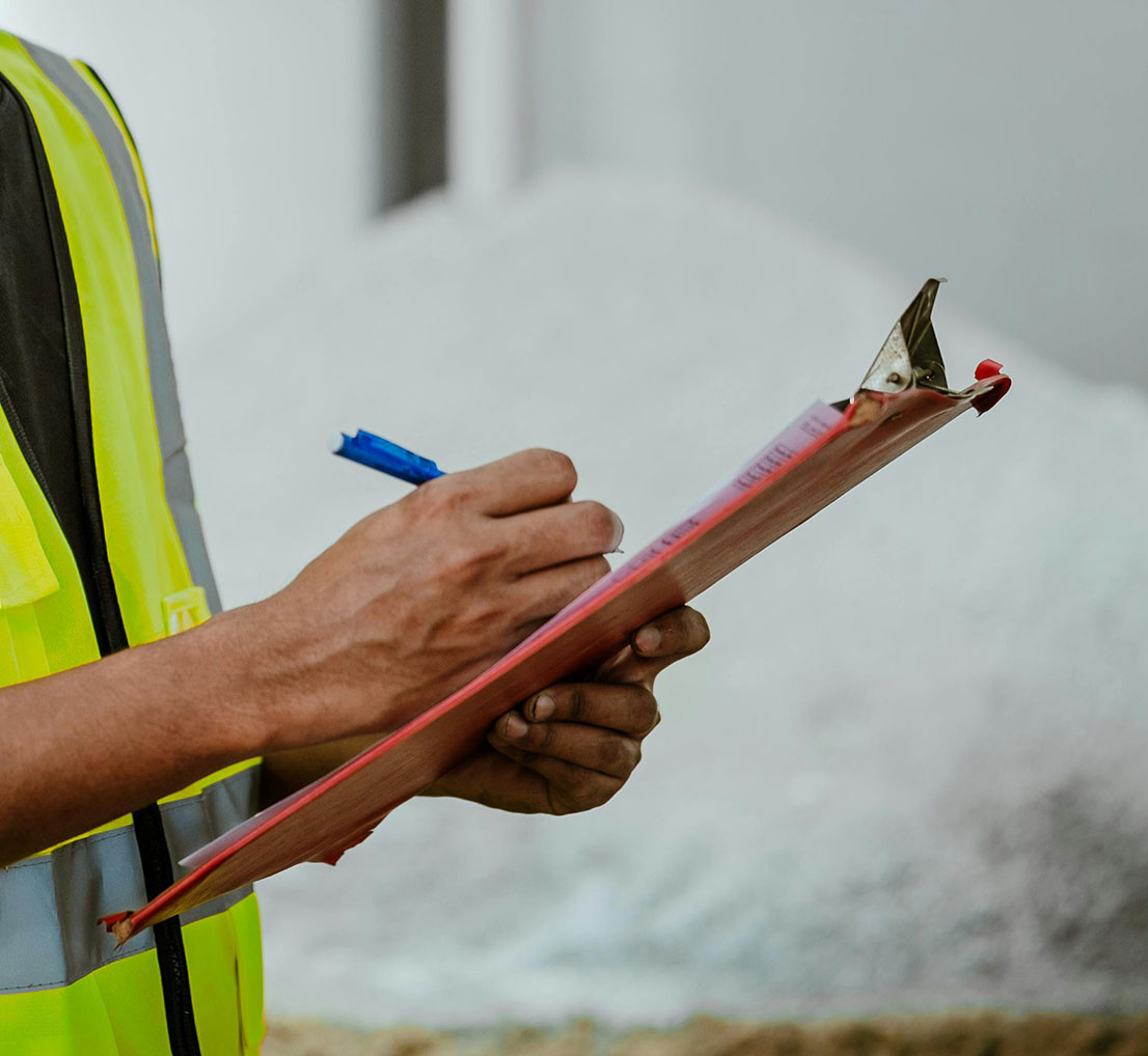H&S consultant in hi-viz jacket holding a clipboard